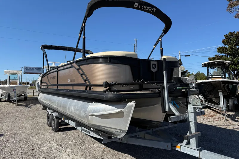 Slide: The Image of 2022 Godfrey Monaco 255 SFL pontoon boat with luxurious seating on a sunny day. - 11