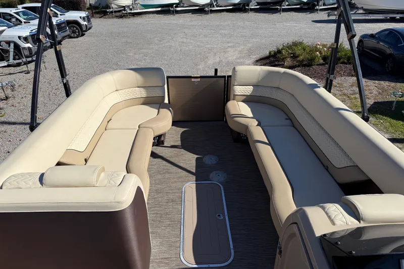 Slide: The Image of Luxurious seating on 2022 Godfrey Monaco 255 SFL pontoon boat, docked by scenic waterfront. - 14