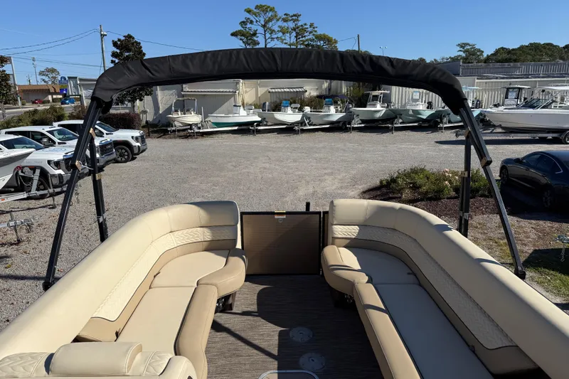 Slide: The Image of 2022 Godfrey Monaco 255 SFL pontoon boat interior with plush seating and modern dashboard. - 15