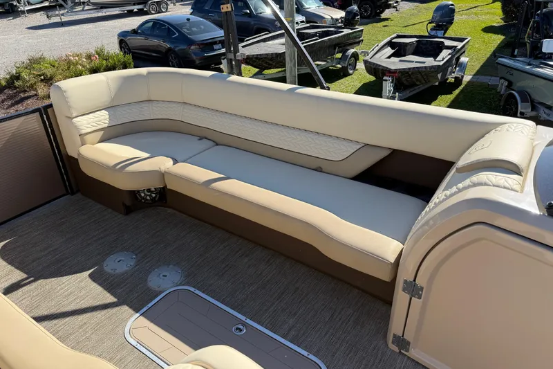 Slide: The Image of 2022 Godfrey Monaco 255 SFL boat interior with luxurious seating on a sunny day. - 16