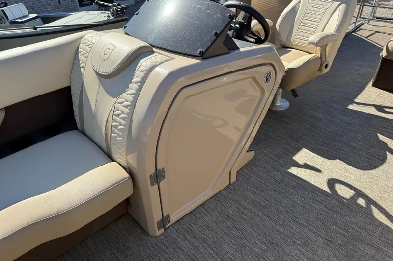 Slide: The Image of 2022 Godfrey Monaco 255 SFL pontoon boat on serene water with scenic shoreline view. - 21