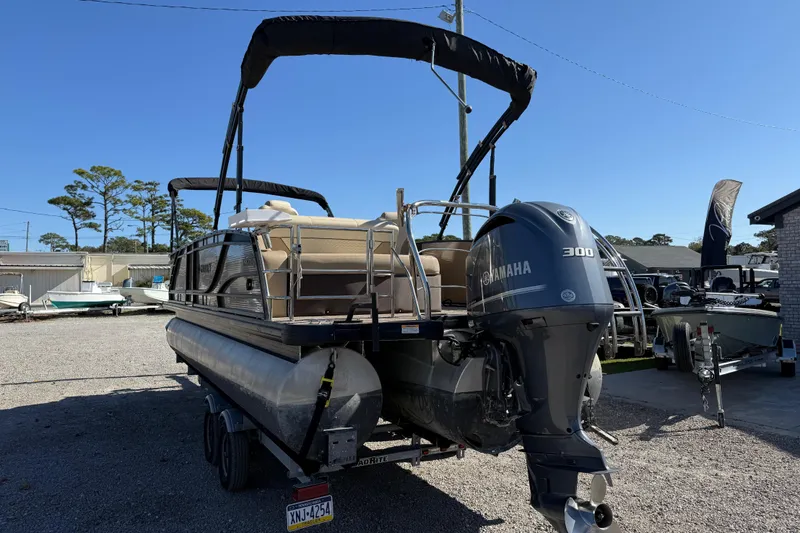 Slide: The Image of 2022 Godfrey Monaco 255 SFL pontoon boat on water, featuring Yamaha engine. - 4