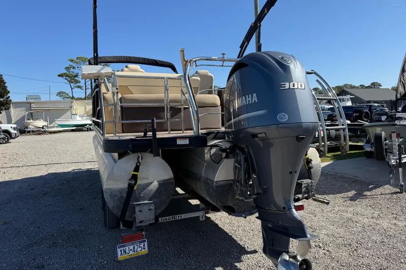 Slide: The Image of 2022 Godfrey Monaco 255 SFL pontoon boat on a serene lake. - 5