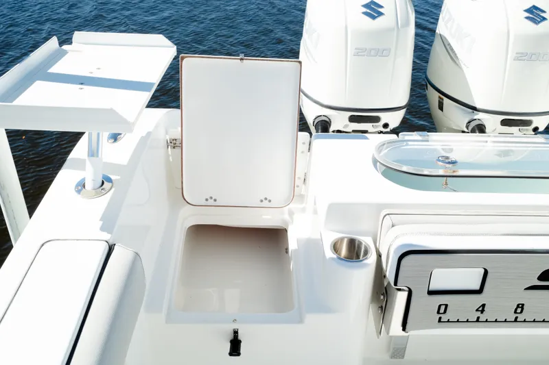 Slide: The Image of 2019 Sea Pro 259 Center Console boat with Suzuki engines, open storage, and fishing station. - 11