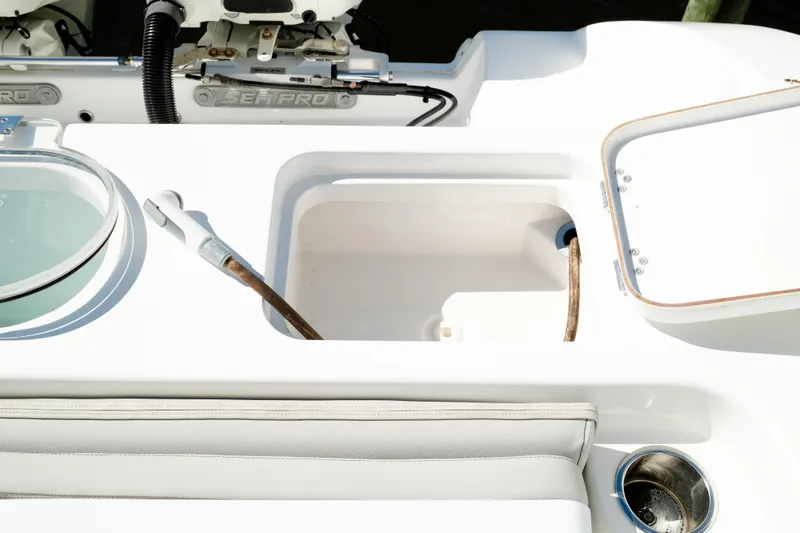 Slide: The Image of 2019 Sea Pro 259 Center Console boat interior with storage compartments and seating. - 13