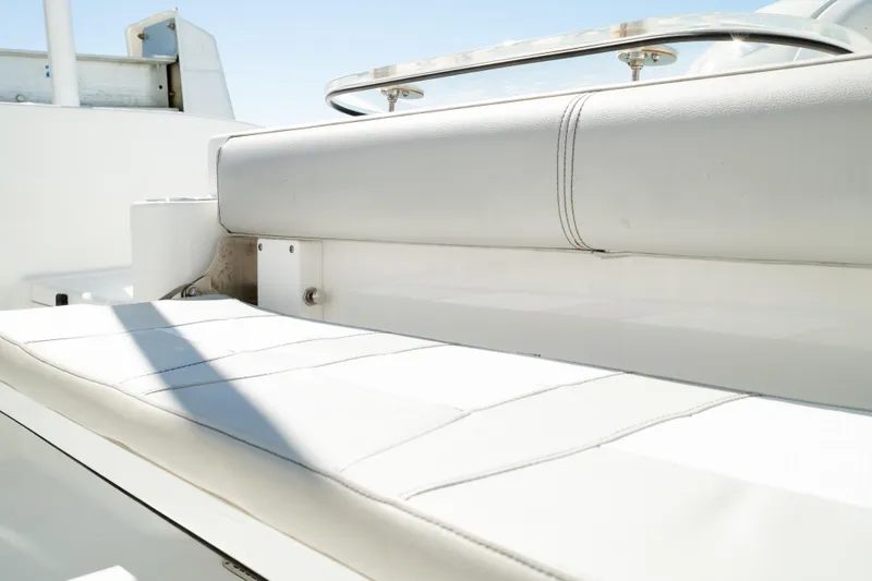 Slide: The Image of 2019 Sea Pro 259 Center Console boat seating, featuring white cushioned upholstery. - 16
