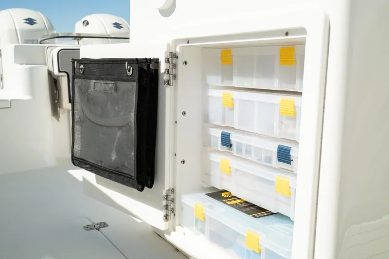 Slide: The Image of Storage compartment on a 2019 Sea Pro 259 Center Console boat with organized tackle boxes. - 22