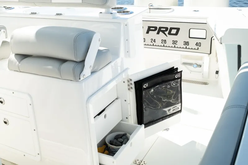 Slide: The Image of 2019 Sea Pro 259 Center Console boat interior with storage compartments and seating. - 24