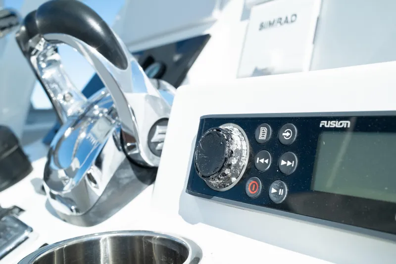 Slide: The Image of Close-up of 2019 Sea Pro 259 Center Console boat controls and Fusion audio system. - 32