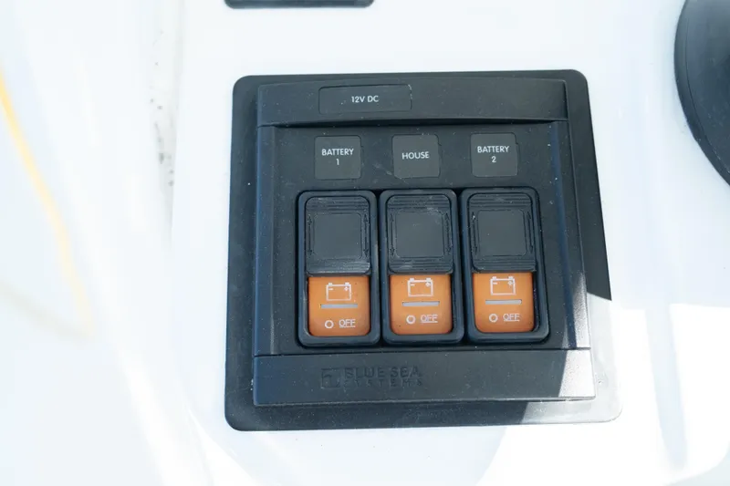Slide: The Image of 2019 Sea Pro 259 Center Console battery switch panel with three switches. - 35
