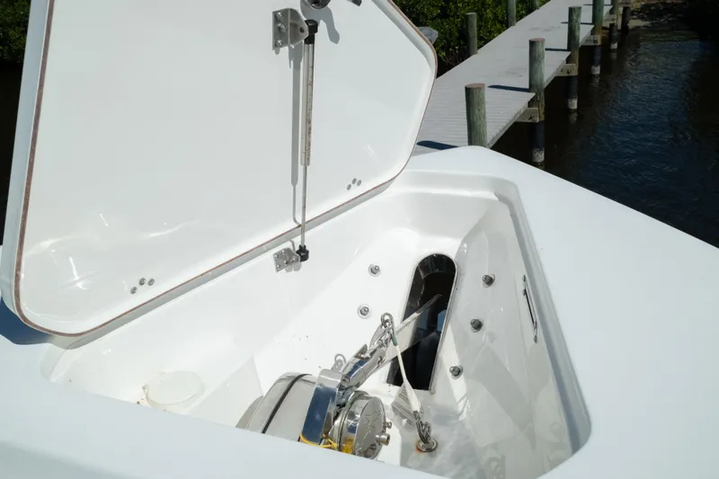 Slide: The Image of 2019 Sea Pro 259 Center Console anchor locker with open hatch by dock. - 50