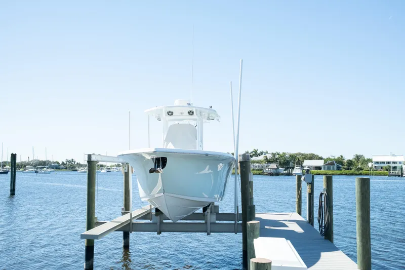 Slide: The Image of 2019 Sea Pro 259 Center Console boat docked on a sunny day. - 58