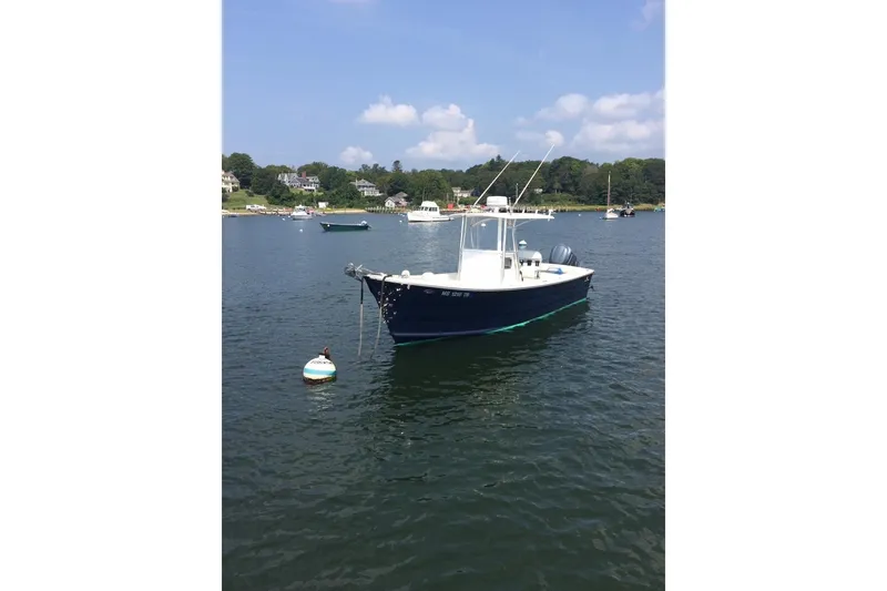 Slide: The Image of 2007 Roth Bilt 24 CC boat on trailer, covered, parked outdoors. - 1