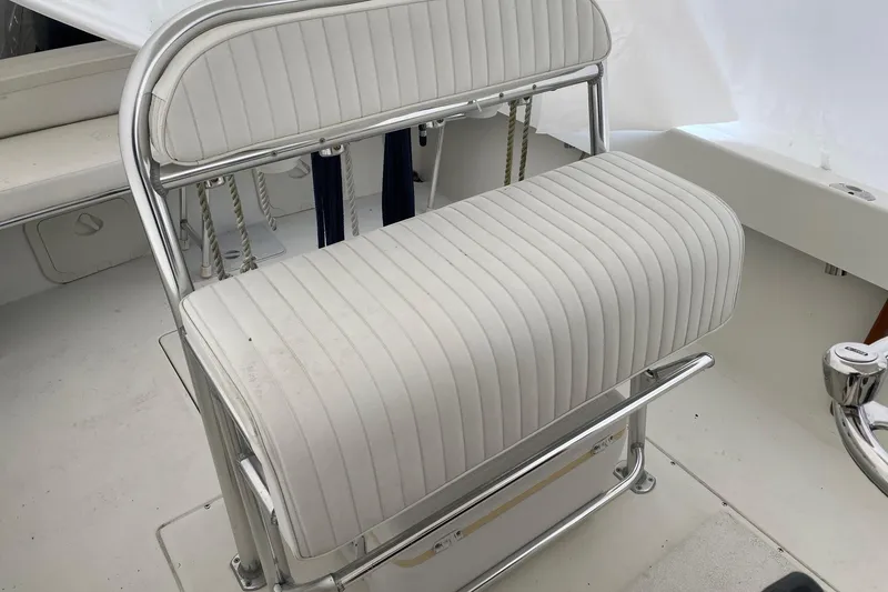 Slide: The Image of White cushioned seat on 2007 Roth Bilt 24 CC boat, featuring chrome frame. - 16