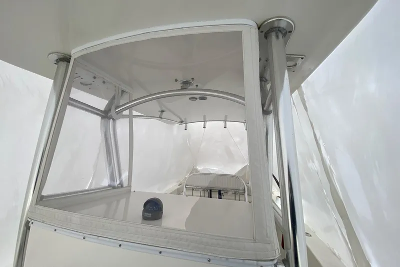 Slide: The Image of 2007 Roth Bilt 24 CC boat interior with clear enclosure and seating. - 18