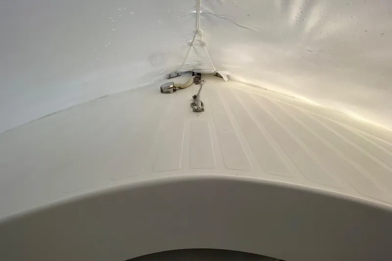 Slide: The Image of 2007 Roth Bilt 24 CC boat interior with white textured surface and metal fittings. - 22