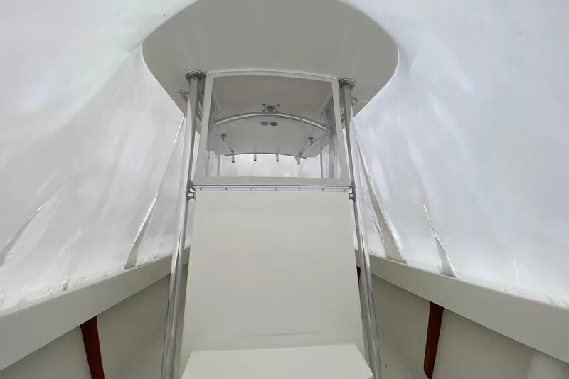 Slide: The Image of 2007 Roth Bilt 24 CC boat interior with white canopy and sleek design. - 23