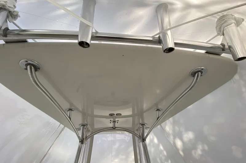 Slide: The Image of 2007 Roth Bilt 24 CC boat's T-top with stainless steel supports and rod holders. - 24
