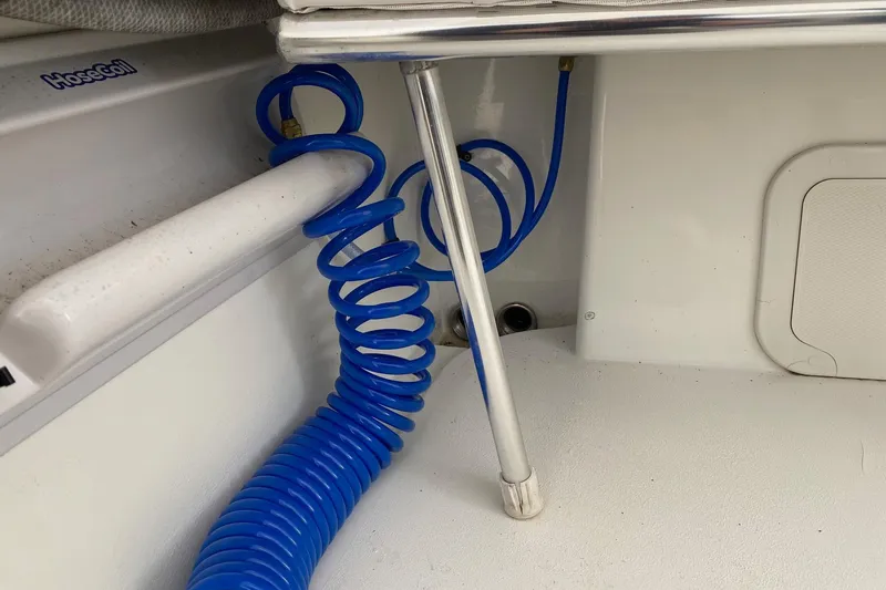 Slide: The Image of Blue coiled hose in 2007 Roth Bilt 24 CC boat interior. - 27