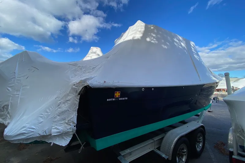 Slide: The Image of 2007 Roth Bilt 24 CC boat covered on trailer under blue sky. - 3
