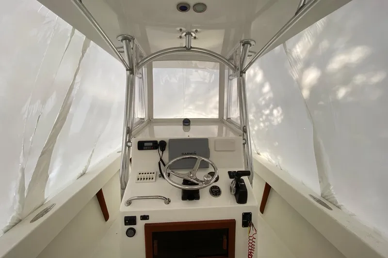 Slide: The Image of 2007 Roth Bilt 24 CC boat helm with steering wheel and navigation equipment. - 5