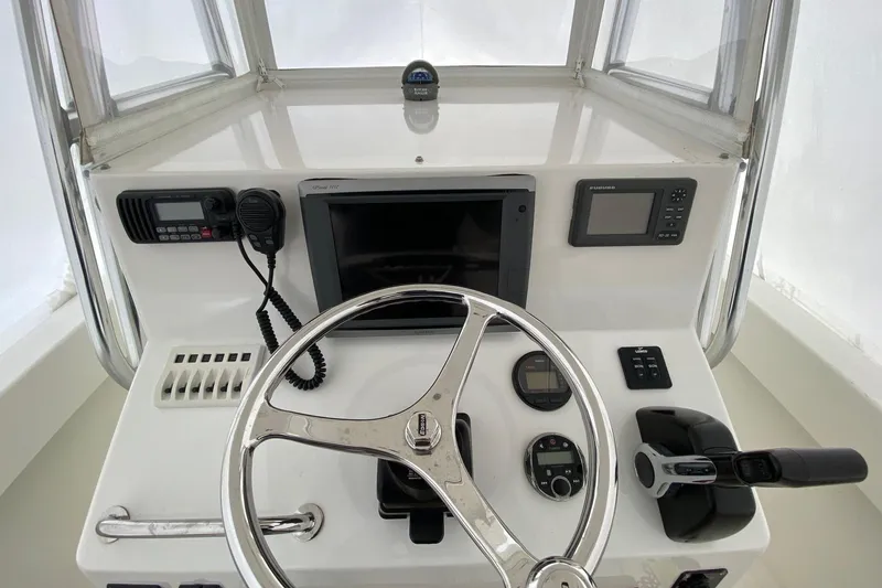 Slide: The Image of 2007 Roth Bilt 24 CC boat dashboard with steering wheel and navigation controls. - 7