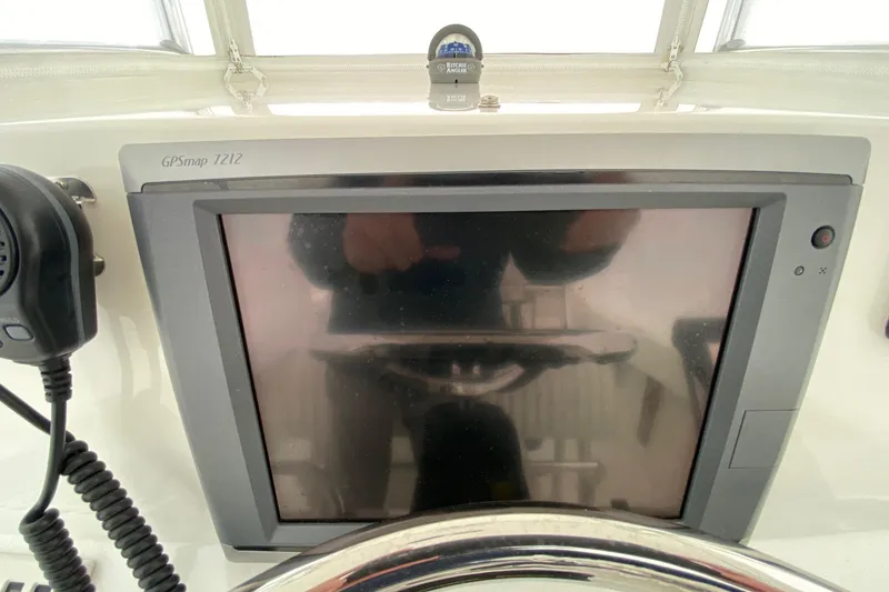 Slide: The Image of 2007 Roth Bilt 24 CC boat dashboard with GPSmap 7212 and radio microphone. - 9