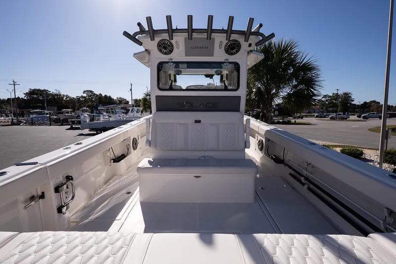 Slide: The Image of 2026 Solace 37 Pilot boat interior with seating and helm station under clear sky. - 11