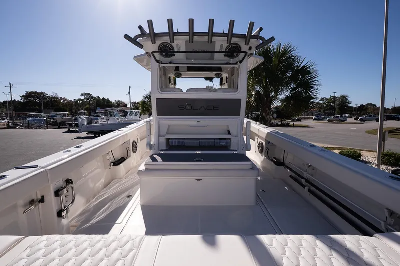 Slide: The Image of 2026 Solace 37 Pilot boat interior with seating and rod holders, under clear blue sky. - 12