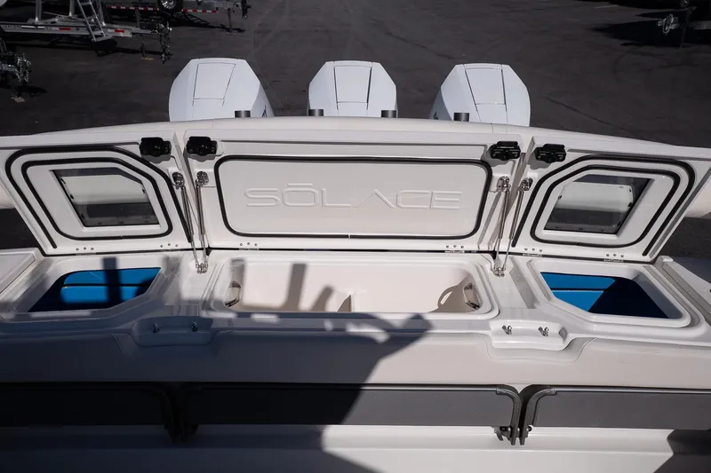 Slide: The Image of 2026 Solace 37 Pilot boat storage compartments with open hatches and visible engines. - 19