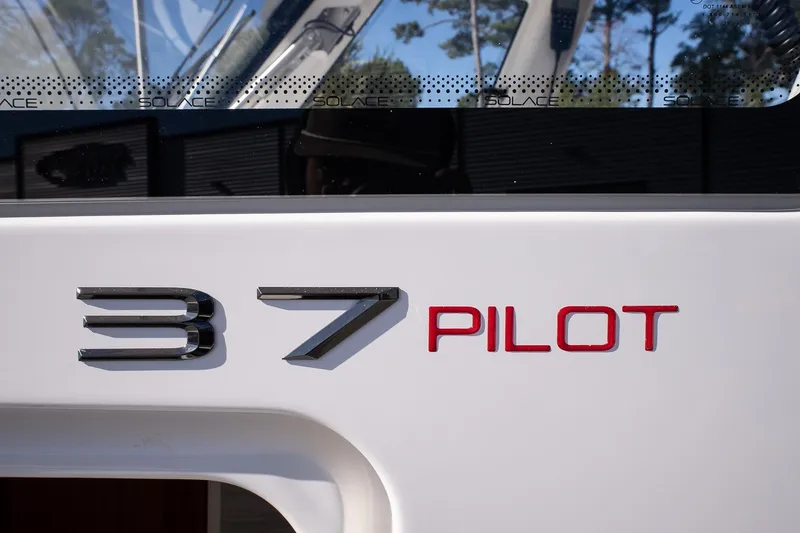 Slide: The Image of 2026 Solace 37 Pilot boat logo on white surface, close-up view. - 24