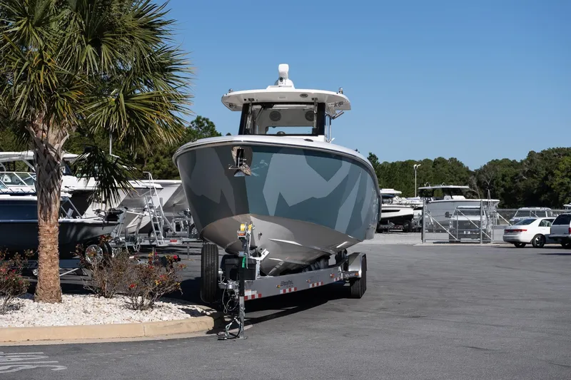 Slide: The Image of 2026 Solace 37 Pilot boat on trailer in sunny parking lot. - 3