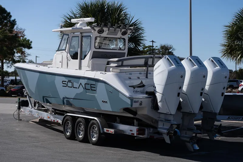 Slide: The Image of 2026 Solace 37 Pilot boat with triple outboard engines on a trailer. - 4