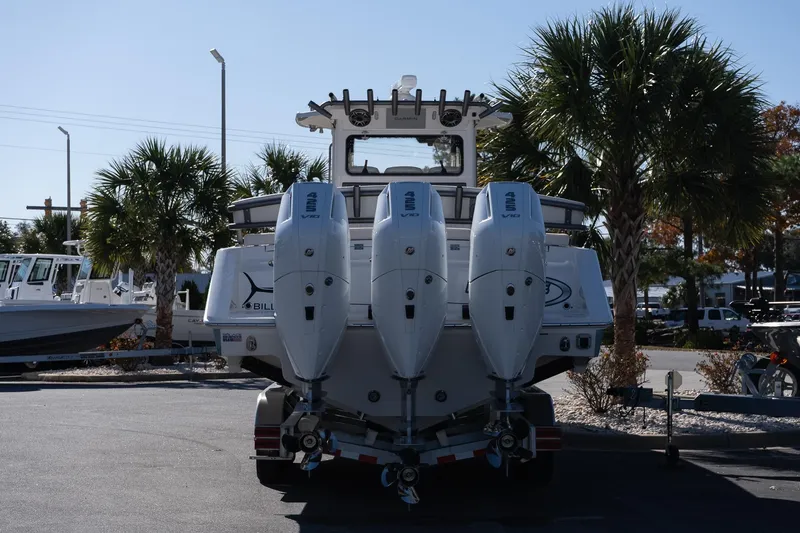 Slide: The Image of 2026 Solace 37 Pilot boat with four powerful outboard engines, parked near palm trees. - 8