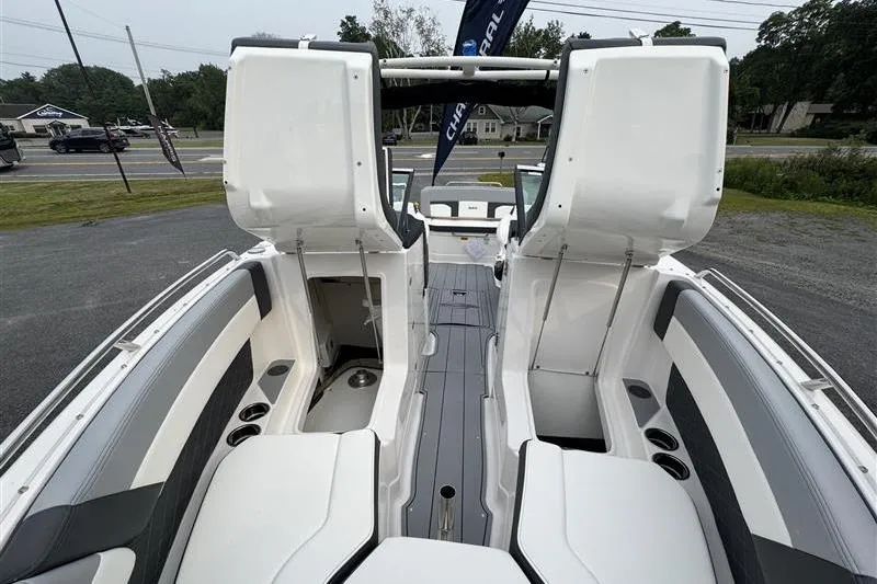 Slide: The Image of 2025 Chaparral 267 SSX boat interior with open storage compartments and seating. - 11