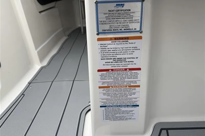 Slide: The Image of 2025 Chaparral 267 SSX yacht certification and safety warning labels on interior panel. - 14