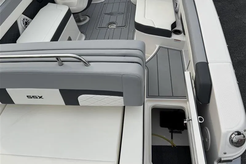 Slide: The Image of 2025 Chaparral 267 SSX boat interior with gray seating and storage compartments. - 16