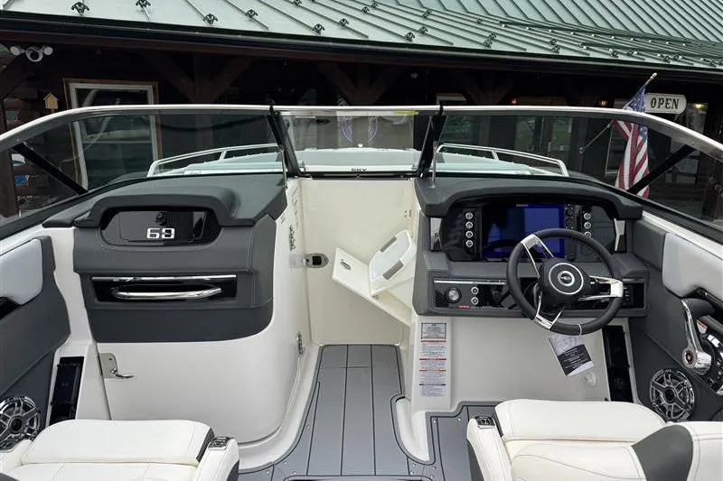 Slide: The Image of Interior view of 2025 Chaparral 267 SSX boat, featuring modern dashboard and steering wheel. - 6