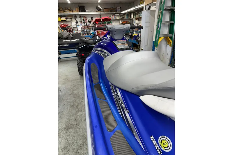 Slide: The Image of 2011 Yamaha WaveRunner VX Cruiser in a garage, blue with gray seat. - 8
