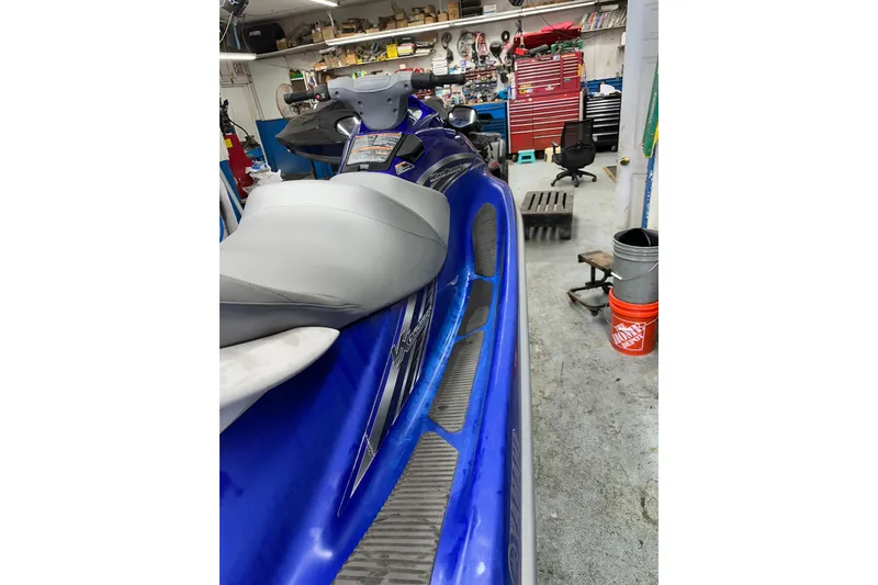Slide: The Image of 2011 Yamaha WaveRunner VX Cruiser in a garage, showcasing sleek blue design and comfortable seating. - 9