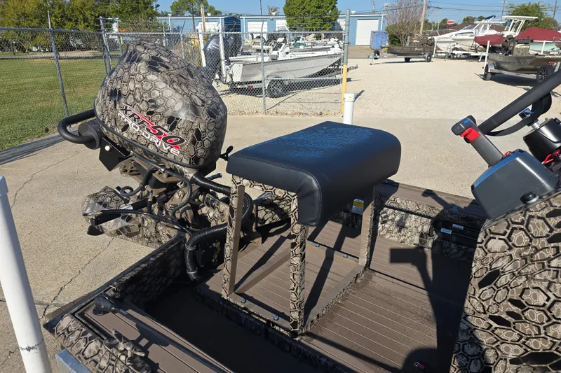 Slide: The Image of 2026 Pro-Drive 1856 SBX TD boat with camo design and powerful motor in a marina. - 11