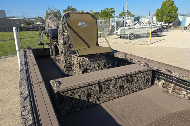 Slide: The Image of 2026 Pro-Drive 1856 SBX TD boat with camouflage design, parked outdoors. - 10