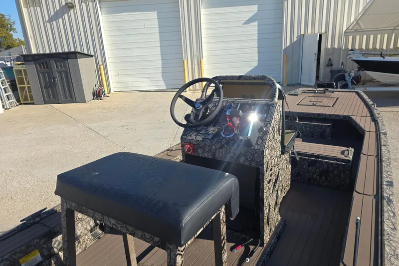 Slide: The Image of 2026 Pro-Drive 1856 SBX TD boat with camouflage design, parked outdoors. - 12