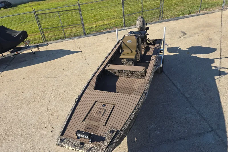 Slide: The Image of 2026 Pro-Drive 1856 SBX TD boat with camouflage design on concrete surface. - 2