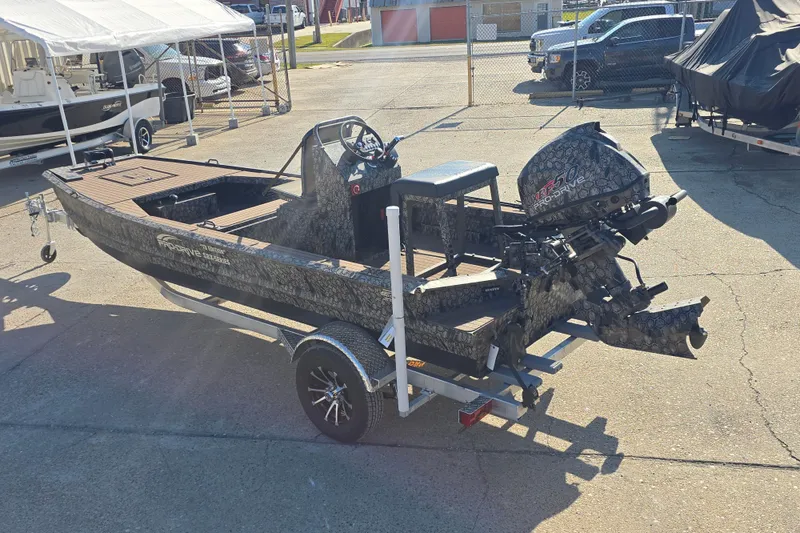 Slide: The Image of 2026 Pro-Drive 1856 SBX TD boat on trailer, parked outdoors in a lot. - 6