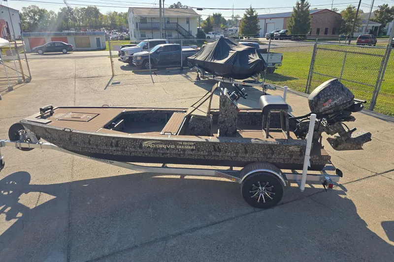 Slide: The Image of 2026 Pro-Drive 1856 SBX TD boat on trailer, parked outdoors in a lot. - 7