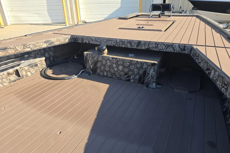 Slide: The Image of 2026 Pro-Drive 1856 SBX TD boat deck with camouflage pattern and storage compartments. - 9