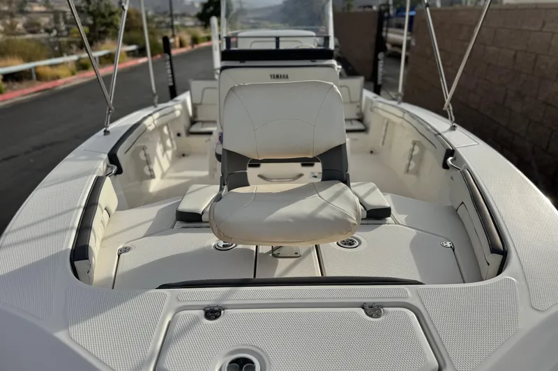 Slide: The Image of 2016 Yamaha Boats 190 FSH Deluxe interior with seating and console view. - 11