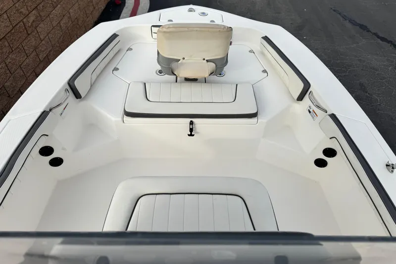 Slide: The Image of 2016 Yamaha Boats 190 FSH Deluxe interior with white seating and cup holders. - 12
