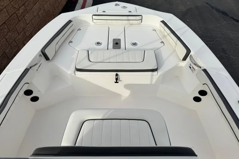 Slide: The Image of 2016 Yamaha Boats 190 FSH Deluxe interior, featuring spacious seating and storage compartments. - 13